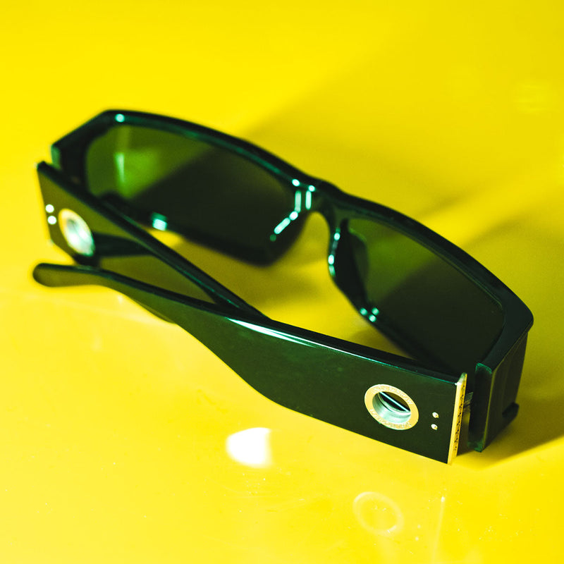 Linda Farrow Brand Blog Post Banner Sunglasses displayed on a table