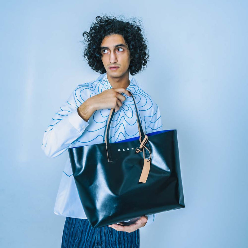 Marni Italian Luxury Fashion Brand Banner Image of a guy wearing clothing and Marni bag