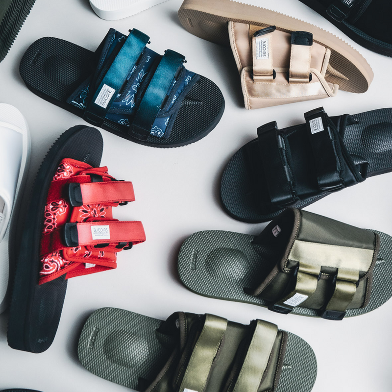 Suicoke - Sandals and Slides displyaed on the floor