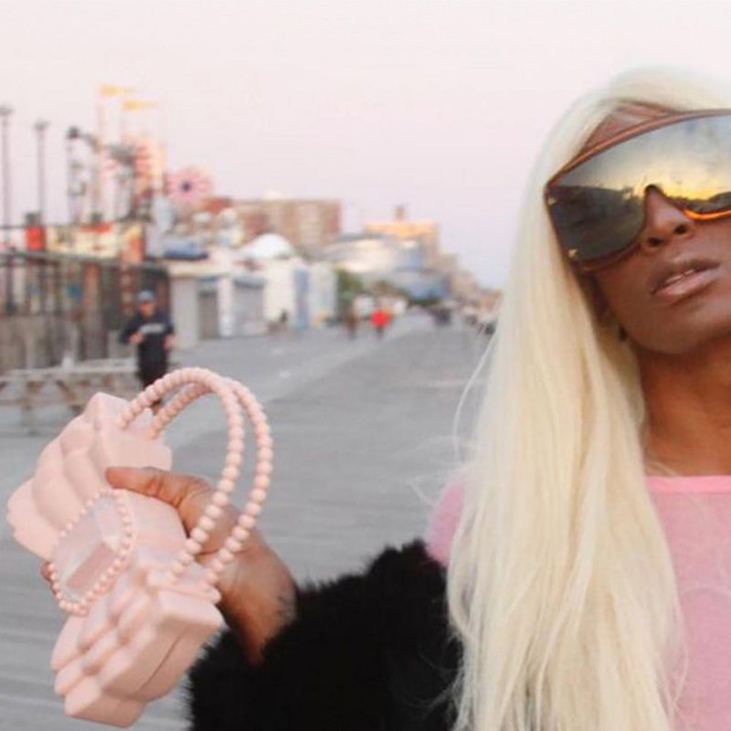 forBitches Blog Post Banner Woman walking with Pink Bow Bag