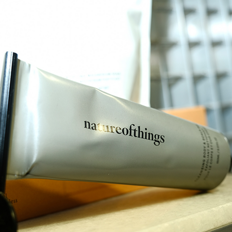 Nature of Things brand with natural body care & wellness products displayed on a window