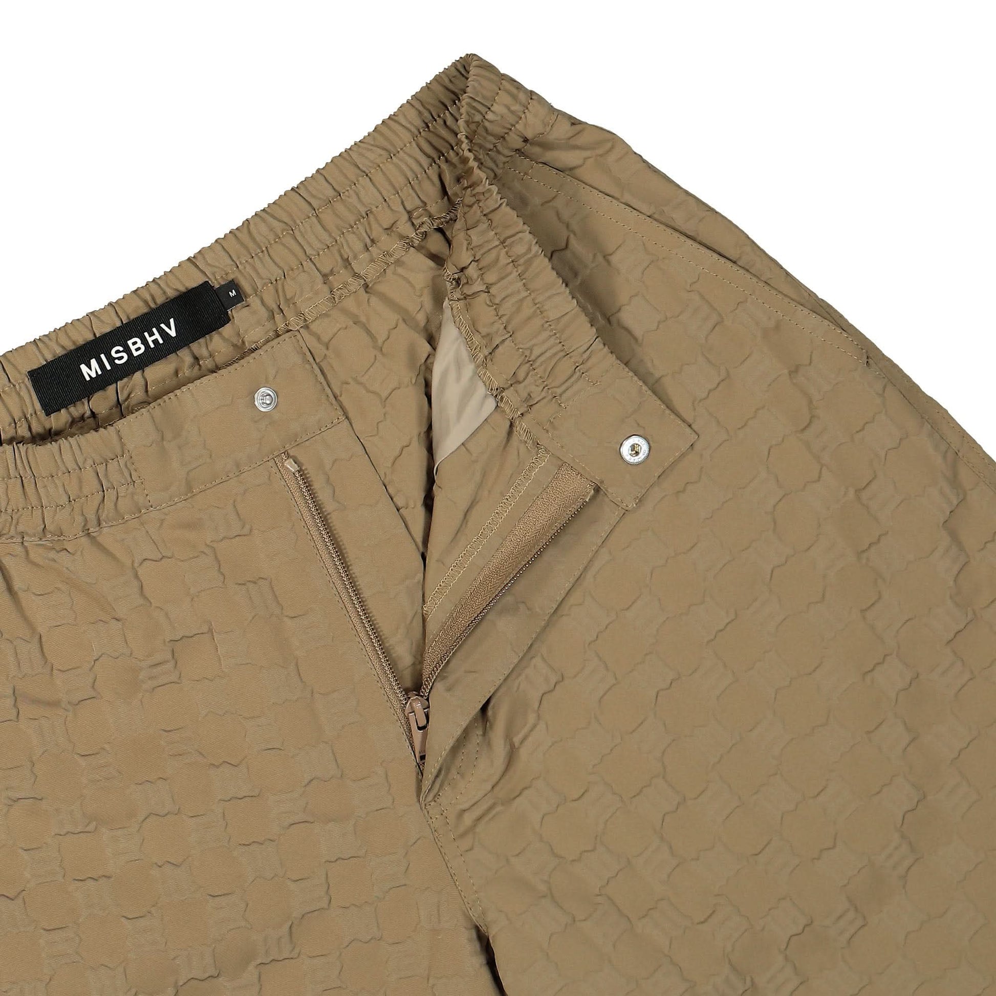 MISBHV Embossed Monogram Milano Tech Trousers Beige Detail view 4 | Gate