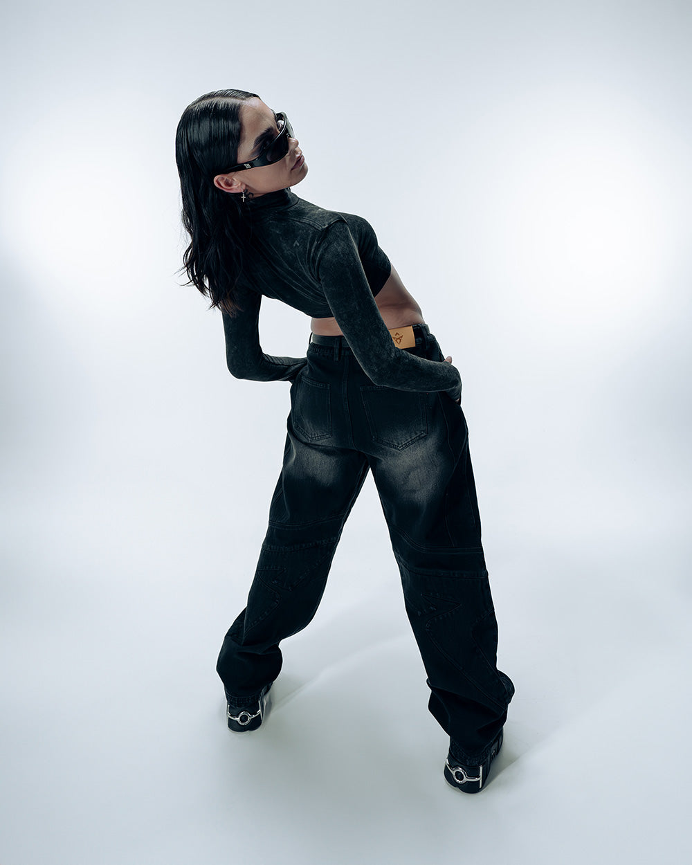 A woman wearing Gate X Cupra Anniversary capsule collection top and jeans