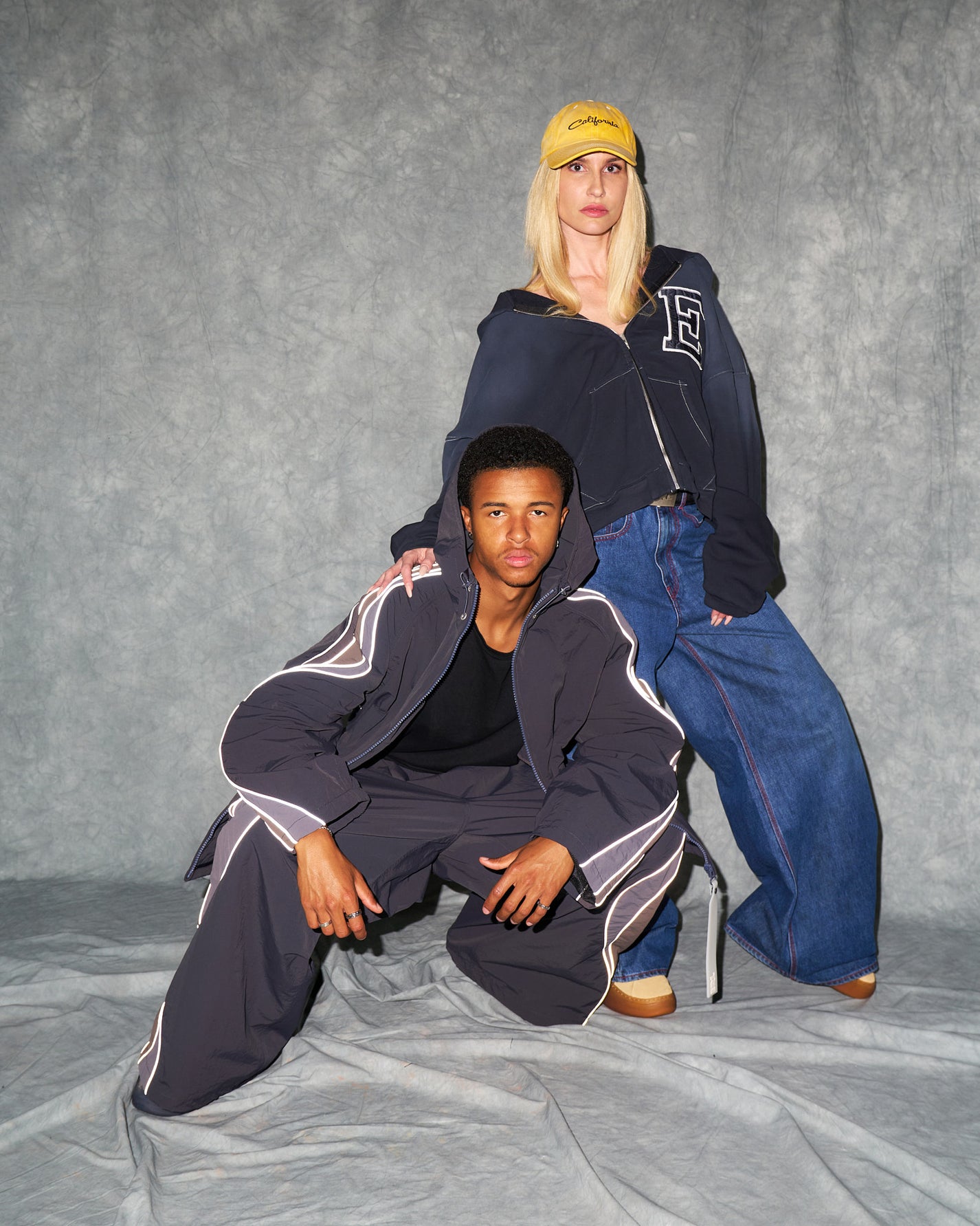 A men and woman wearing ERL streetwear clothing and footwear