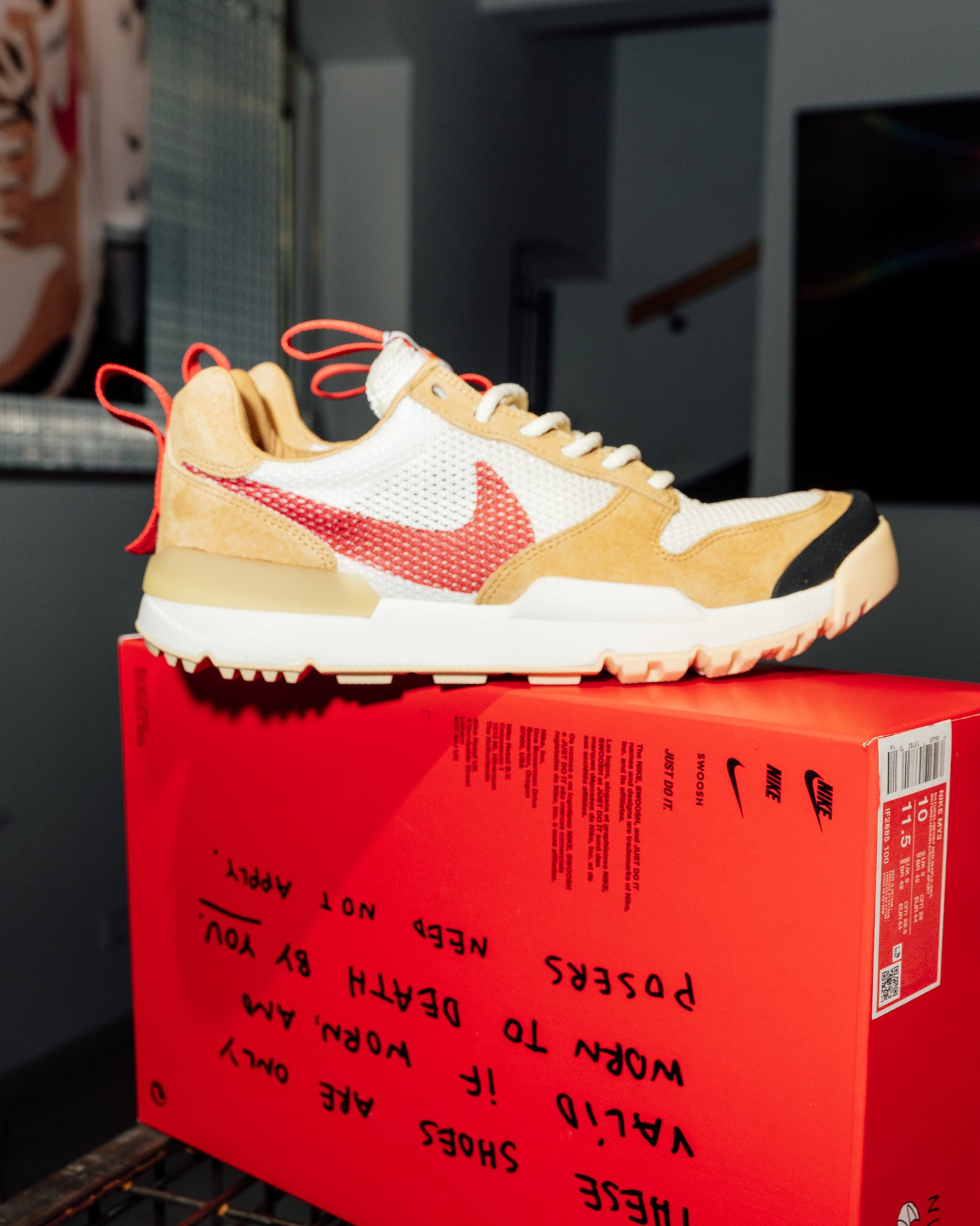 Tom Sachs x Nike Mars Yard 3.0 Beige sneaker with red accents on a red box