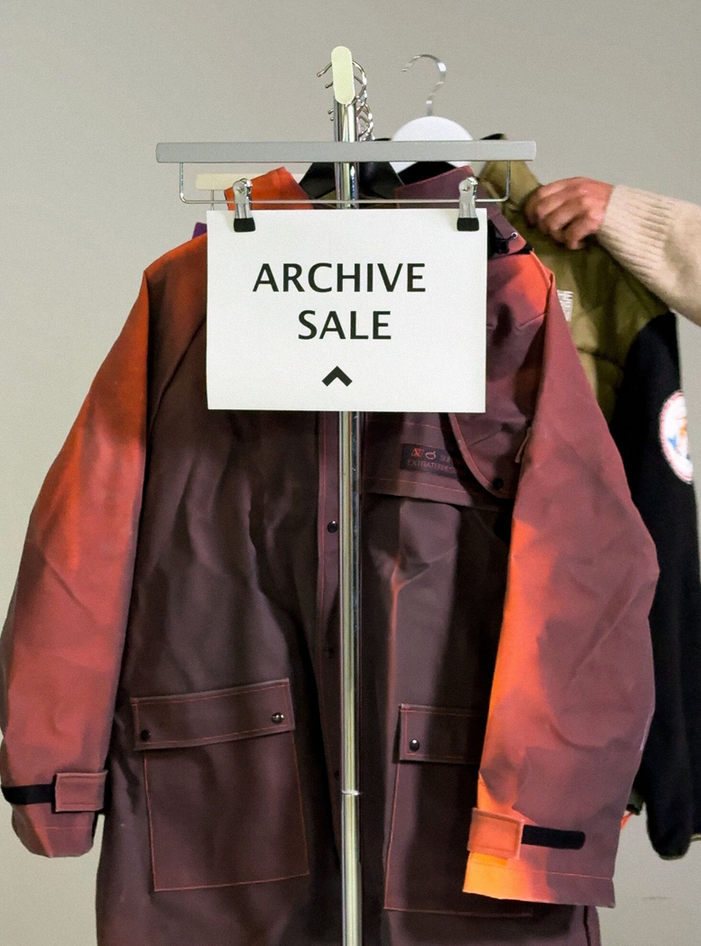 Clothing rack with an “ARCHIVE SALE” sign